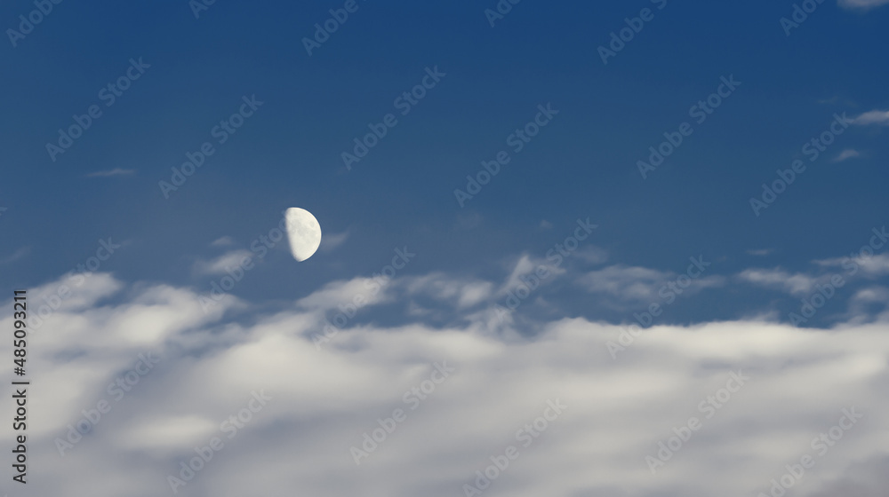 A crescent moon flying across the evening dark sky. It reflects sunlight and so far is the only visible object in the sky. A crescent moon flying across the evening dark sky. It reflects sunlight and so far is the only visible object in the sky.