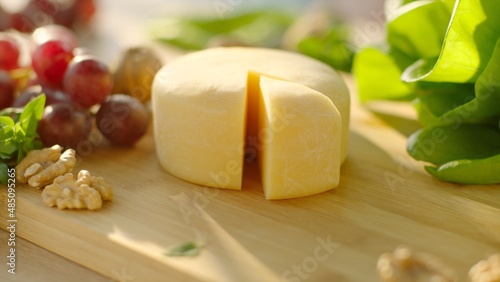 Still life of Cheese served with green, grape and walnut