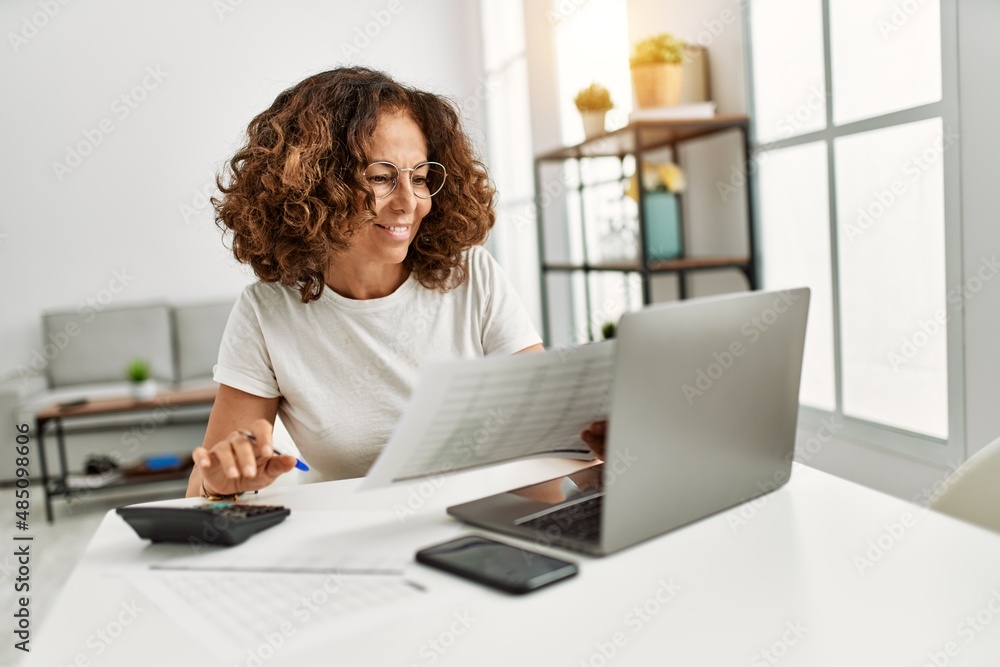 Middle age hispanic woman smiling confident working at home Middle age hispanic woman smiling confident working at home