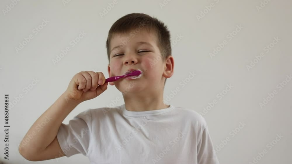 kid boy brushing his teeth using tooth brush and oral paste, cleaning teeth. kid boy brushing his teeth using tooth brush and oral paste, cleaning teeth.