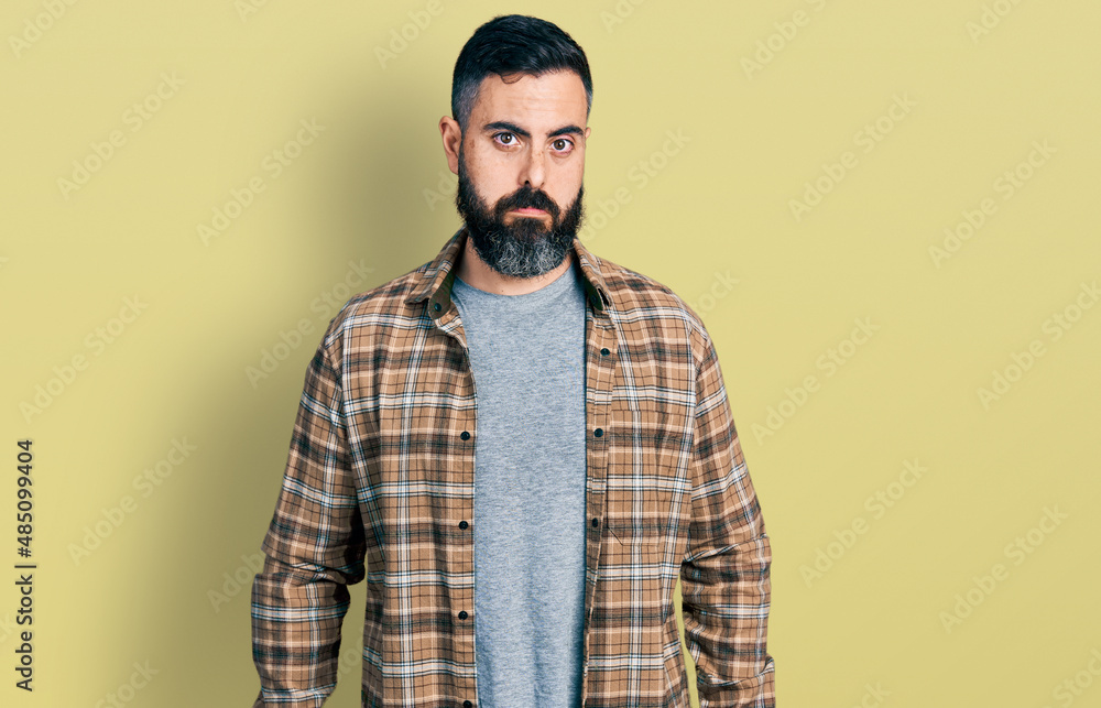 Hispanic man with beard wearing casual shirt depressed and worry for distress, crying angry and afraid. sad expression. Hispanic man with beard wearing casual shirt depressed and worry for distress, crying angry and afraid. sad expression.