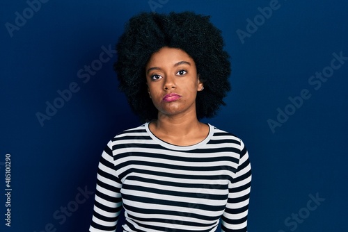 Young african american woman wearing casual clothes relaxed with serious expression on face. simple and natural looking at the camera.