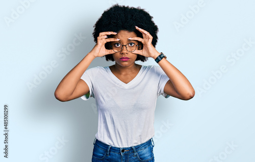 Young african american woman wearing casual white t shirt trying to open eyes with fingers, sleepy and tired for morning fatigue