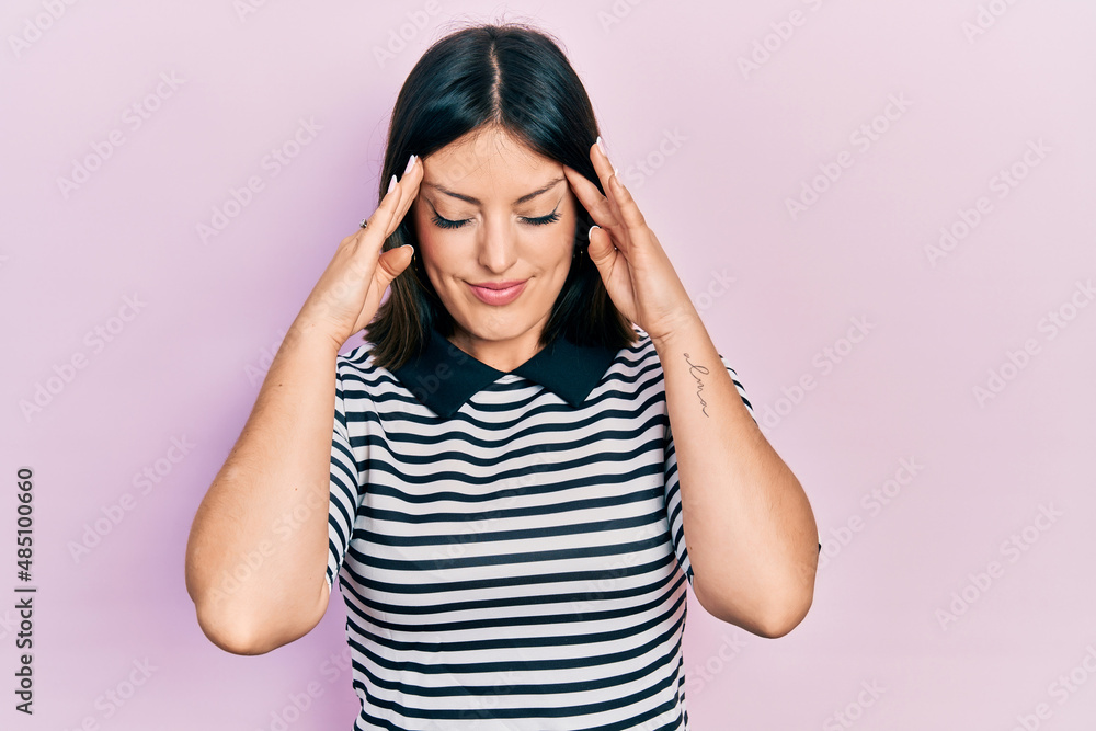 Young hispanic woman wearing casual clothes with hand on head for pain in head because stress. suffering migraine. Young hispanic woman wearing casual clothes with hand on head for pain in head because stress. suffering migraine.