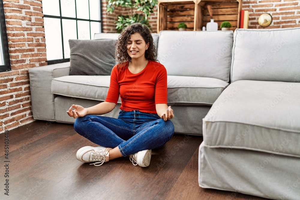 Obraz premium Young latin woman smiling confident doing yoga exercise at home