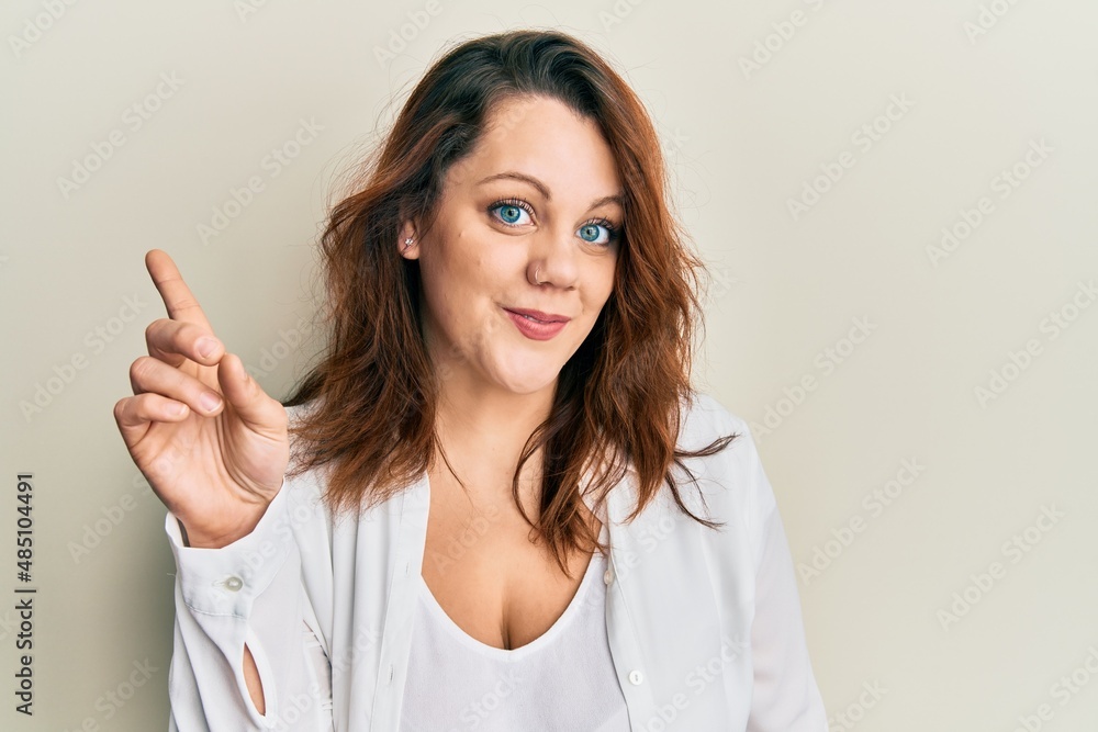 Young caucasian woman wearing casual clothes smiling with an idea or question pointing finger up with happy face, number one Young caucasian woman wearing casual clothes smiling with an idea or question pointing finger up with happy face, number one