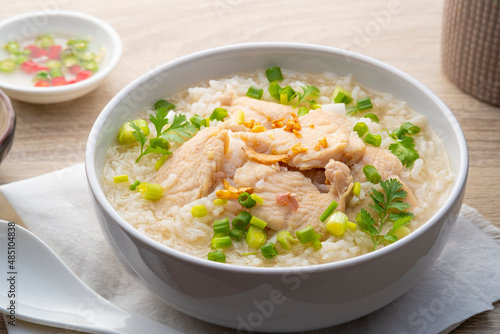 Chicken Porridge,rice soup with sliced chicken breast in white bowl.Asian breakfast style photo