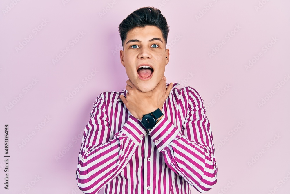 Young hispanic man wearing casual clothes shouting suffocate because painful strangle. health problem. asphyxiate and suicide concept. Young hispanic man wearing casual clothes shouting suffocate because painful strangle. health problem. asphyxiate and suicide concept.