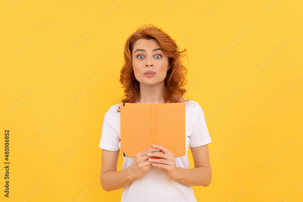 surprised girl hold copybook on yellow background, knowledge surprised girl hold copybook on yellow background, knowledge