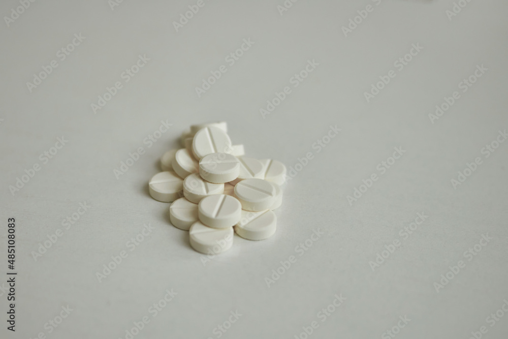 white pills in bulk on white background white pills in bulk on white background