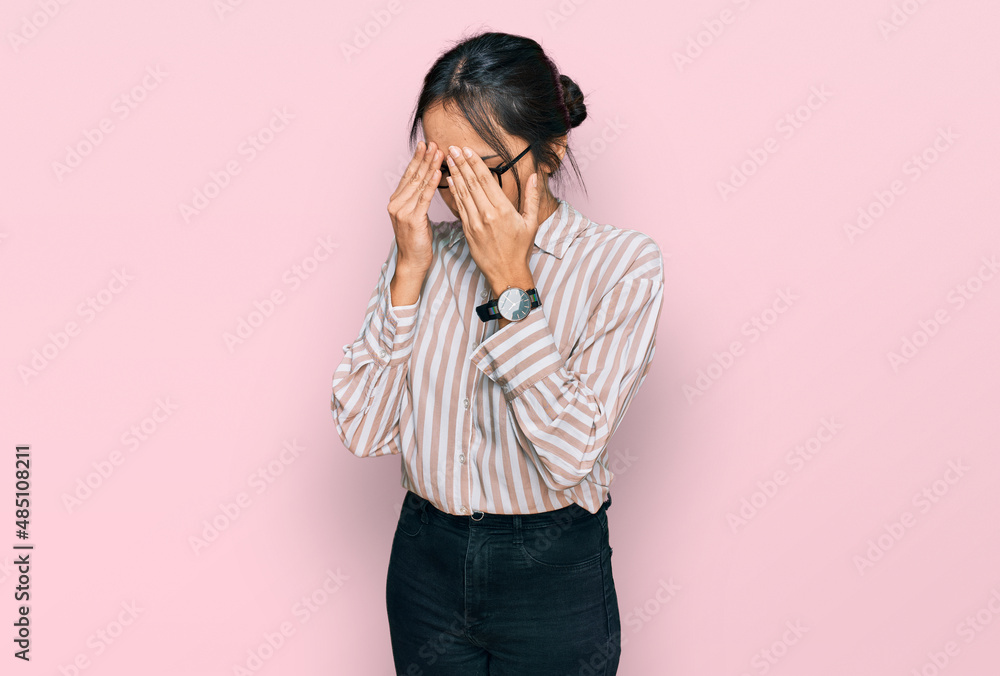 Young hispanic girl wearing casual clothes and glasses rubbing eyes for fatigue and headache, sleepy and tired expression. vision problem Young hispanic girl wearing casual clothes and glasses rubbing eyes for fatigue and headache, sleepy and tired expression. vision problem