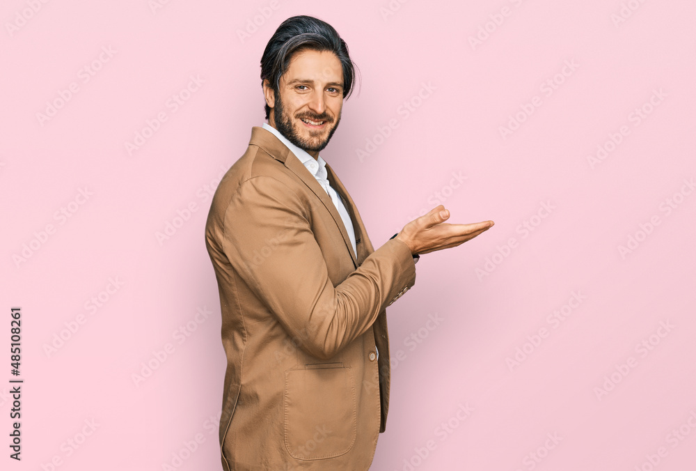 Young hispanic man wearing business clothes pointing aside with hands open palms showing copy space, presenting advertisement smiling excited happy Young hispanic man wearing business clothes pointing aside with hands open palms showing copy space, presenting advertisement smiling excited happy