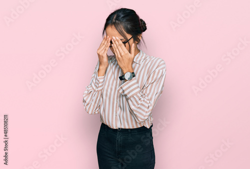 Young hispanic girl wearing casual clothes and glasses rubbing eyes for fatigue and headache, sleepy and tired expression. vision problem