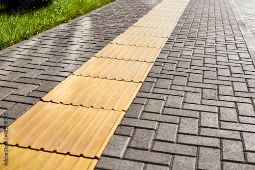 Φωτογραφία Yellow tactile paving on walkway, tactile ground surface indicators for blind an
