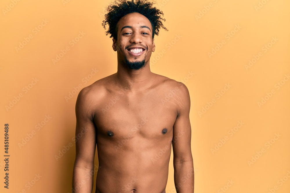 Young african american man with beard using boxing protection with a happy and cool smile on face. lucky person. Young african american man with beard using boxing protection with a happy and cool smile on face. lucky person.