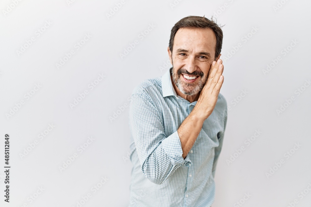 Middle age hispanic man with beard standing over isolated background hand on mouth telling secret rumor, whispering malicious talk conversation Middle age hispanic man with beard standing over isolated background hand on mouth telling secret rumor, whispering malicious talk conversation