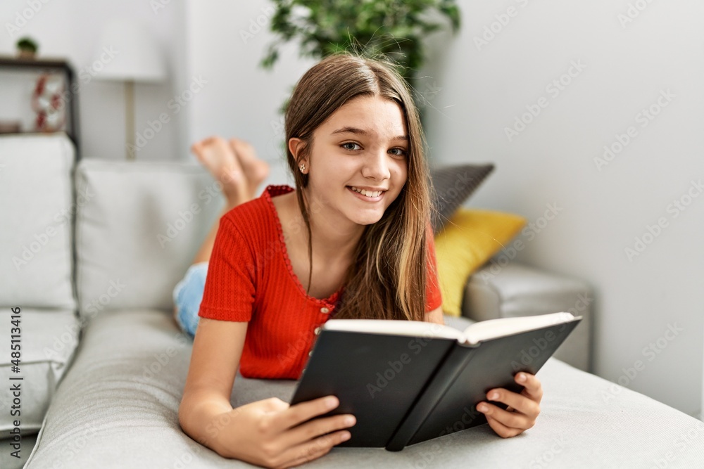 Adorable girl smiling confident reading book at home Adorable girl smiling confident reading book at home