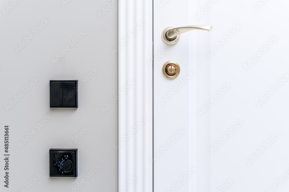 Stylish bronze door handle and lock on a white new interior door Stylish bronze door handle and lock on a white new interior door