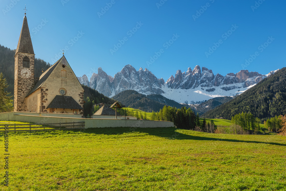 Santa Maddalena village with church and beautiful Dolomiti mountains, Val Di Funes, Dolomites, Italy in sunny morning