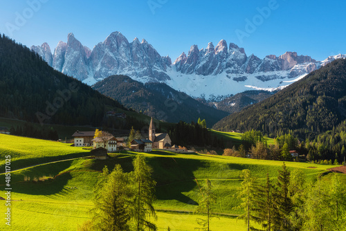 Sunny spring landscape of Dolomites Alps. Famous Santa Maddalena village with church and beautiful Dolomiti mountains