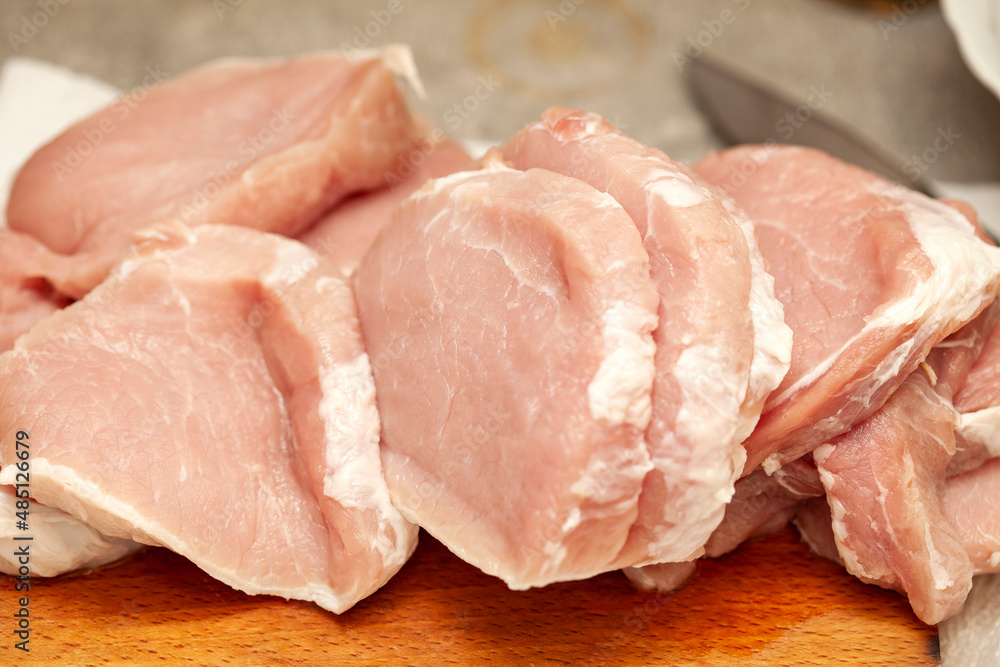 Lots of uncooked fresh juicy raw fat pork chop meat pieces, freshly cut up, food, object closeup, nobody. Unprocessed pig meat, raw chops set, loin cuts up close, kitchen scene, nutrition concept Lots of uncooked fresh juicy raw fat pork chop meat pieces, freshly cut up, food, object closeup, nobody. Unprocessed pig meat, raw chops set, loin cuts up close, kitchen scene, nutrition concept