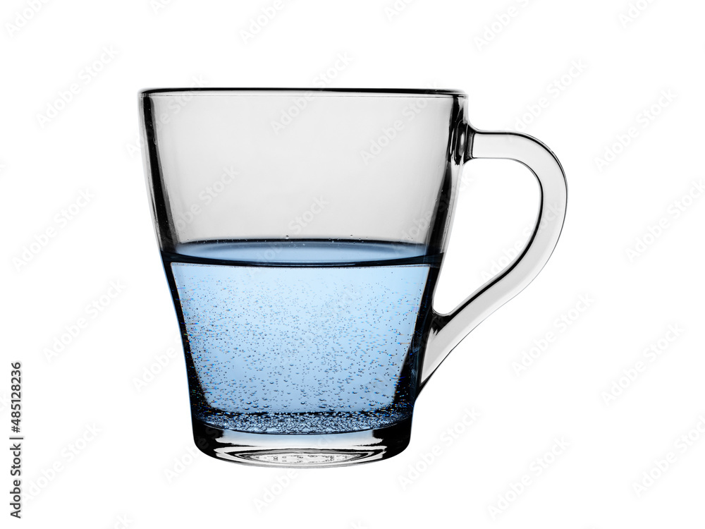 Glass cup with sparkling mineral water. On a white background, close-up Glass cup with sparkling mineral water. On a white background, close-up