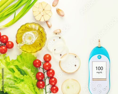 Fototapeta Naklejka Na Ścianę i Meble -  Diabetes control. Natural vegetables, olive oil and glucometer with the result of good glycemia on white background with copy space. Keto diet. Concept of no diabetes and control of glycemia with diet