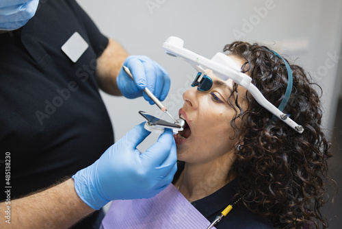 Принти на полотні Doctor orthodontist installs a system for diagnosing jaw joints and occlusion fo
