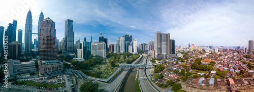 Modern Skyscraper and Traditional Housing Area at Kuala Lumpur, Malaysia photo