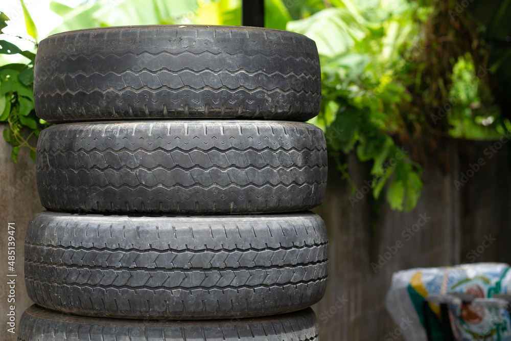 Old tire is placed on the tire storage rack in home. Photos | Adobe Stock