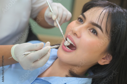 Young woman having teeth examined by dentist in dental clinic  teeth check-up and Healthy teeth concept