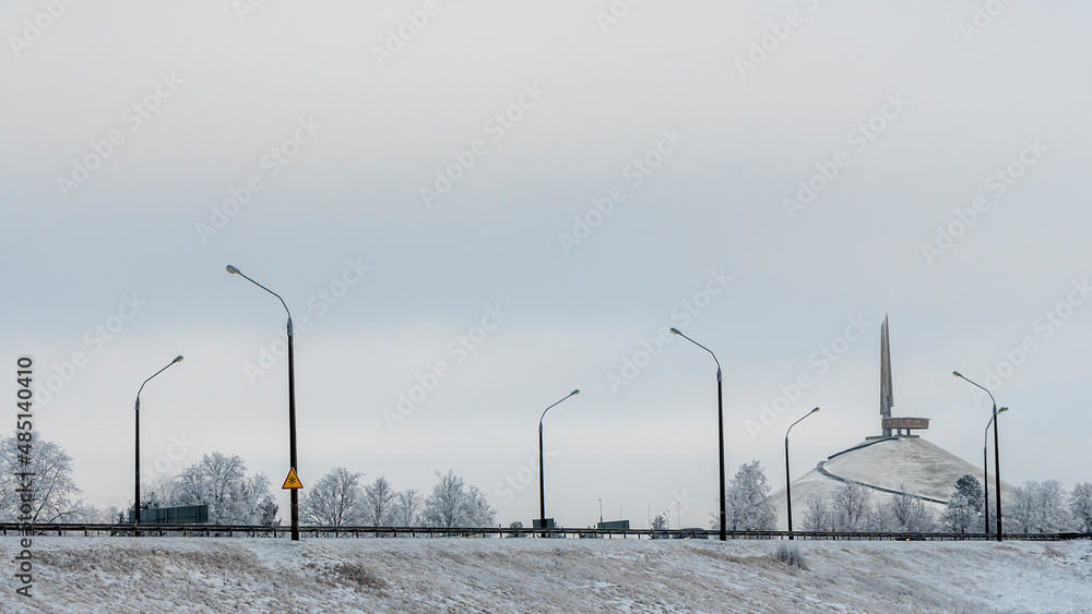 Panorama of the highway in winter. In the background is the memorial complex Mound of Glory.