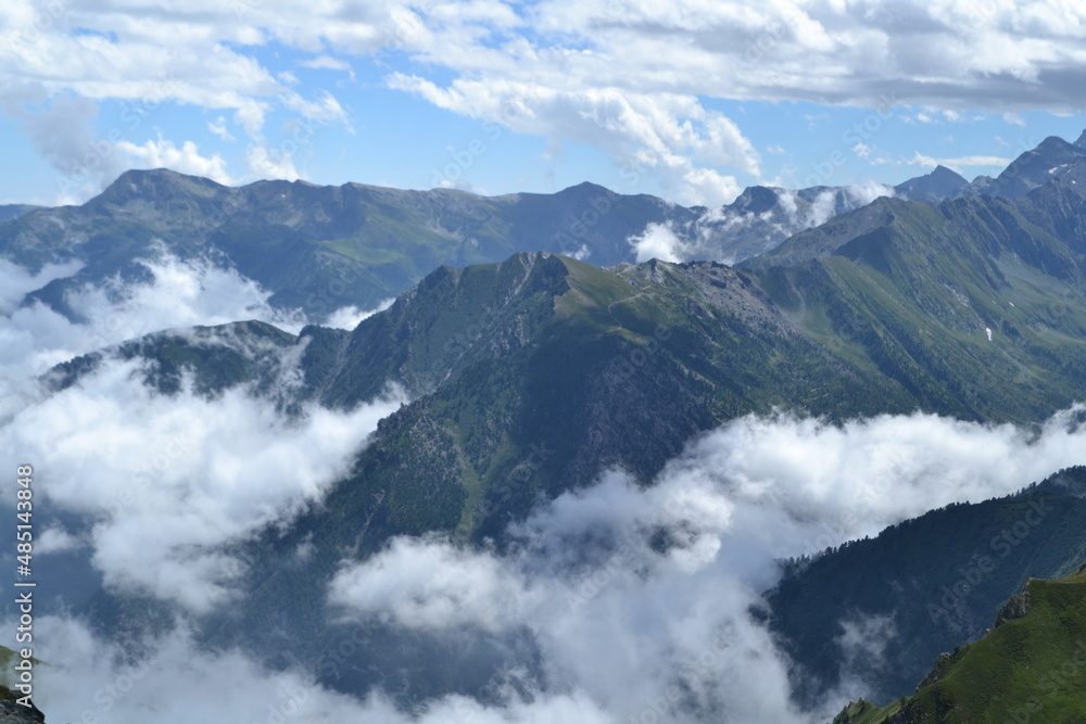 blue sky and white clouds over the rock of Bric Bouchet between the French alps of the Queyras region on the French-Italian border