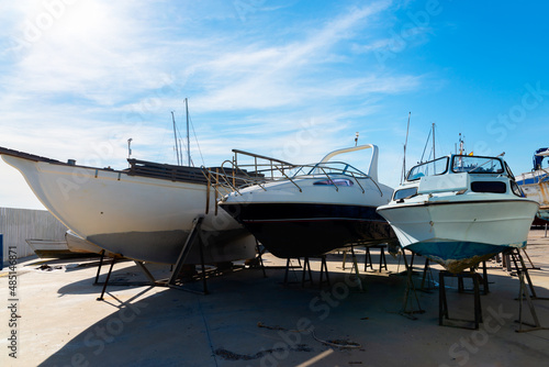Boat on the stand in the marine workshop on the beautiful sunny day, a place for maintenance and parking boats