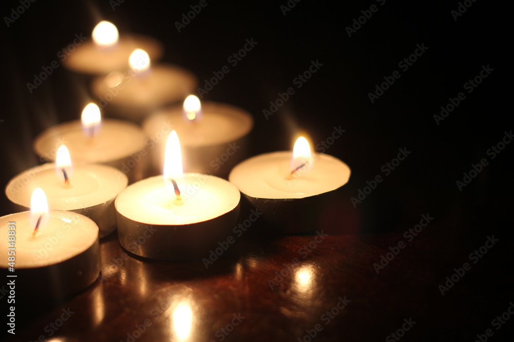 Light several candles on a wooden table