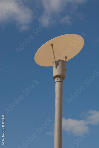 metal lamppost with blue sky in the background