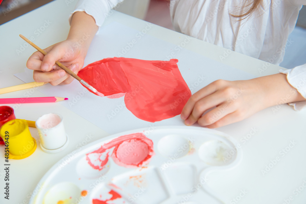 a child paints a heart to his mother for valentine's day a child paints a heart to his mother for valentine's day