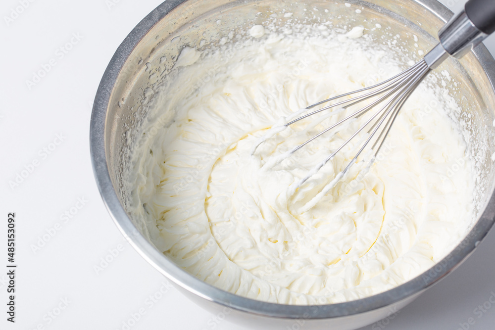 white whipped cream in metal bowl white whipped cream in metal bowl