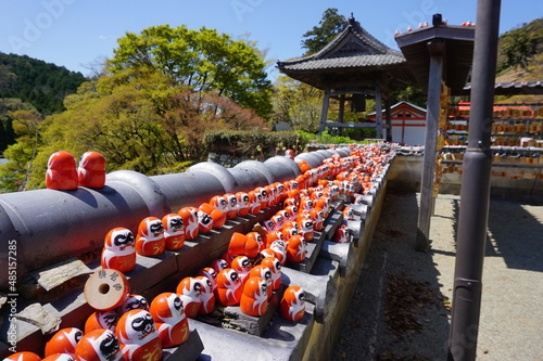 Dharma dolls lined up on the wall of Katsuo-ji Temple, Minoo City, Osaka, Japan photo