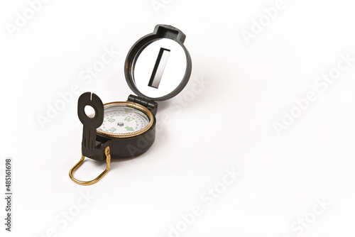 Tourist magnetic compass with a heliograph on a white background.Isolate. photo