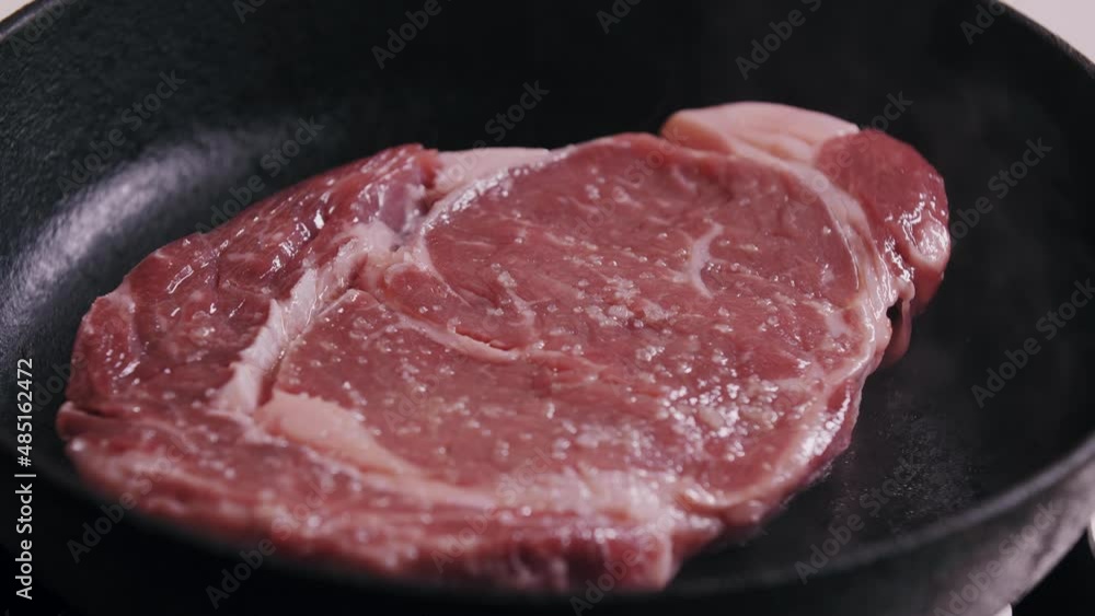 Cooking ribeye steak in a cast-iron skillet Cooking ribeye steak in a cast-iron skillet