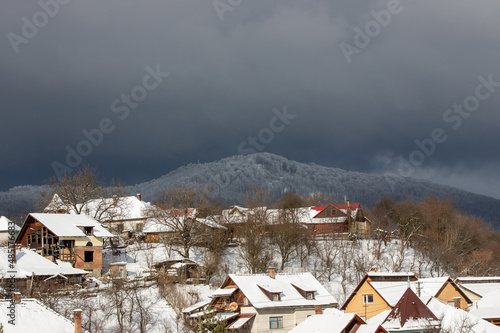 storm clouds over a village in winter
