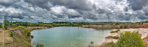 lake near the forest on a cloudy gloomy summer day
