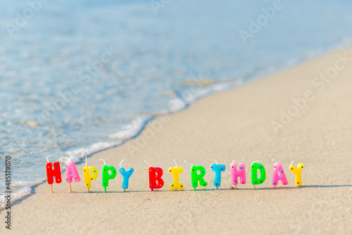 Canvas Print Happy birthday colorful candles on a beach