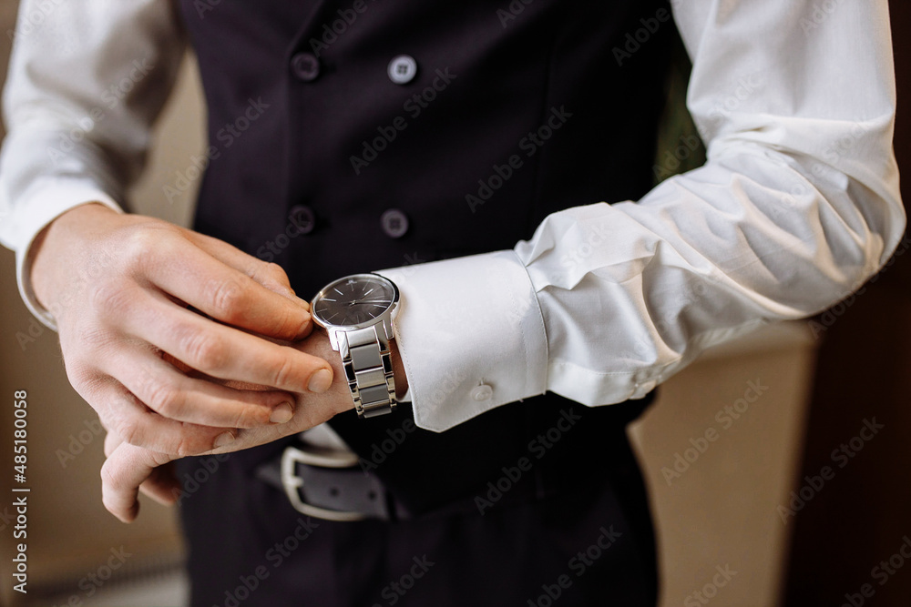 businessman looking at his watch on his hand, watching the time businessman looking at his watch on his hand, watching the time