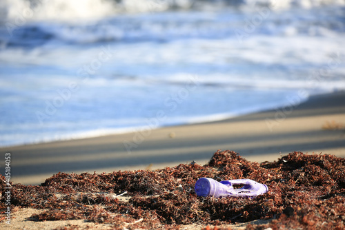 Garbage, plastic bottles, tires, papers and dirt on Santa Lucia beach, Caribbean Sea, Atlantic Ocean, Puerto Rico, USA.