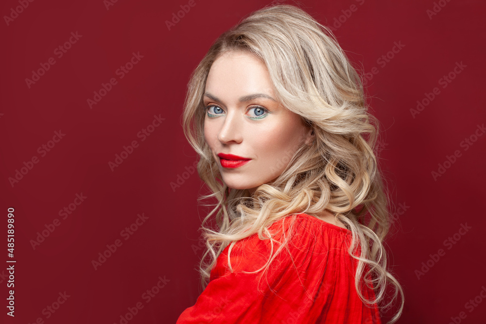 Stylish blonde lady with blond curly hair and red lips makeup on red background Stylish blonde lady with blond curly hair and red lips makeup on red background