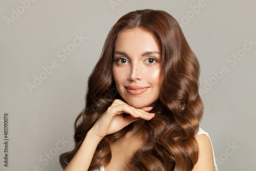 Portrait of a beautiful young woman with Long wavy hair, healthy clear skin and gentle smile