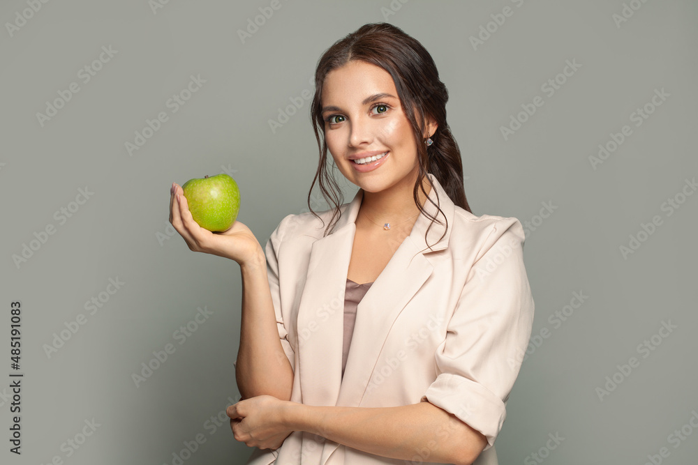 Portrait of a young happy business woman holding green apple Portrait of a young happy business woman holding green apple