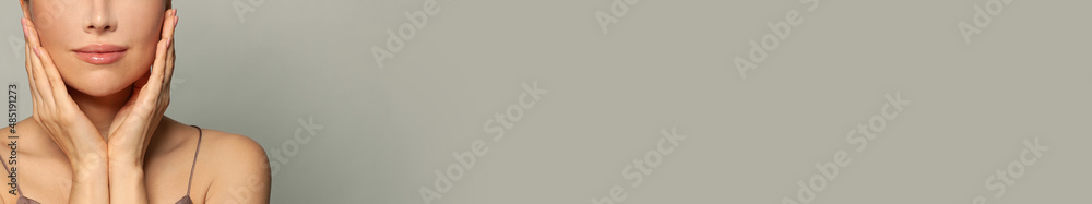 Closeup female face on gray banner background with copy space Closeup female face on gray banner background with copy space